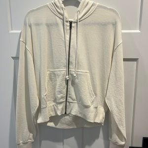 A cream\white colored zip up hoodie, from True Craft, woman’s small.
